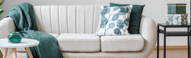 Image of couch with pillows and blanket
